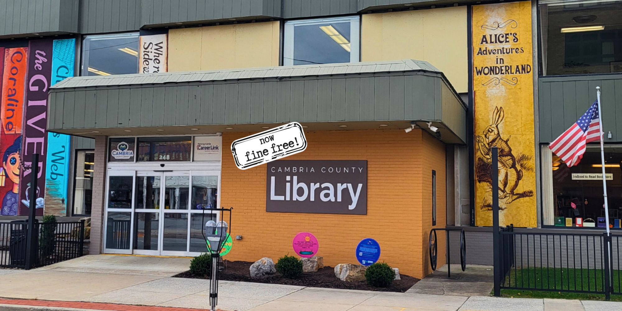 Beaverdale library has a red roof, door, and black shutters.