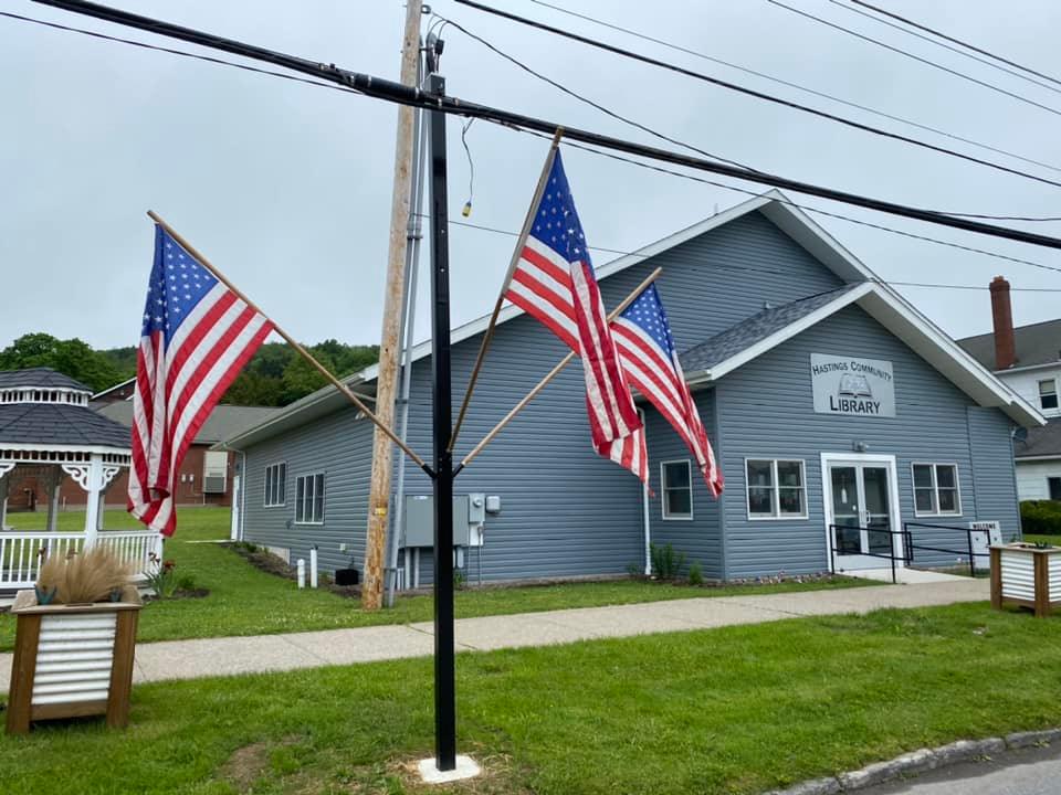 Beaverdale library has a red roof, door, and black shutters.